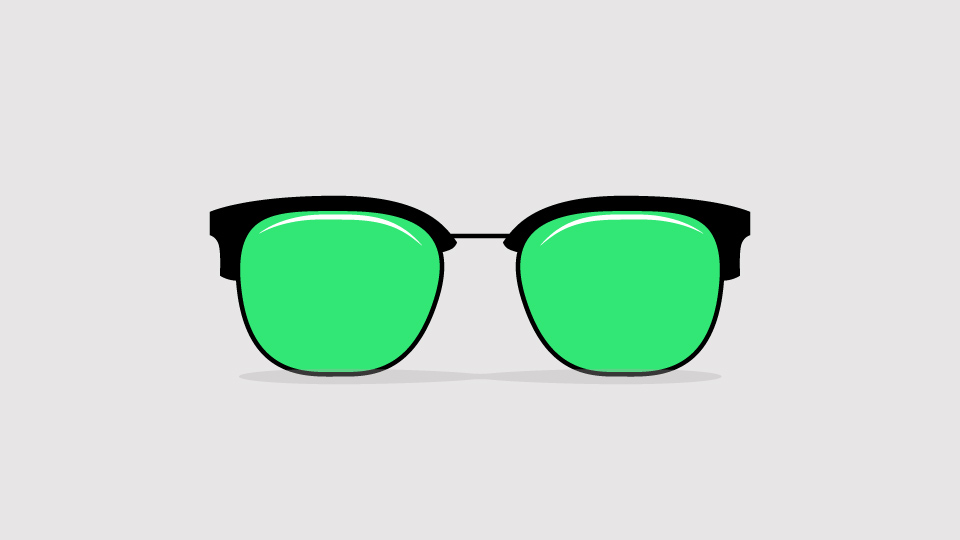 A pair of glasses that have black frames and green lenses.