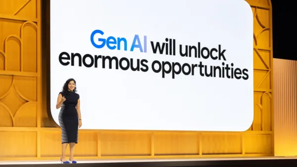 Female speaker on stage in front of screen displaying text: Gen AI will unlock enormous opportnities