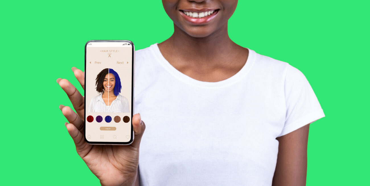 Person holding a phone showing an AR haircut app