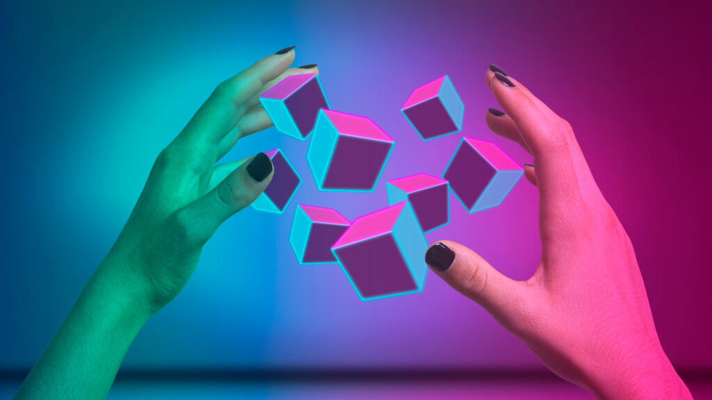 Hands surrounding augmented reality cubes