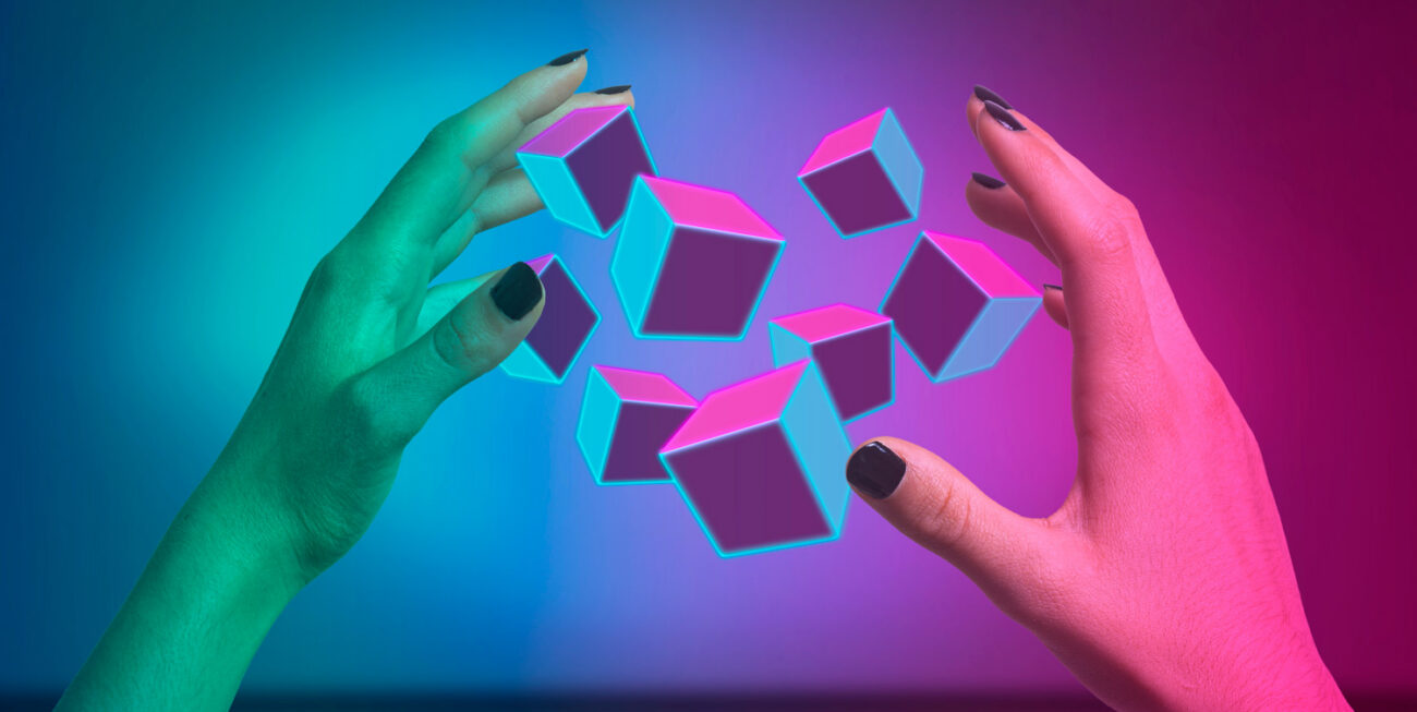 Hands surrounding augmented reality cubes