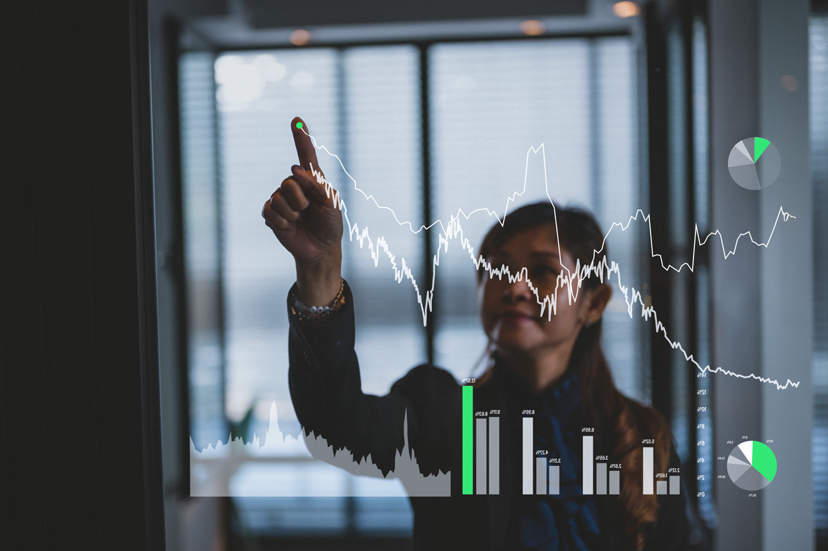 Person interacting with transparent data visualizations, highlighting real-time analysis, performance tracking, and data-driven decision making.