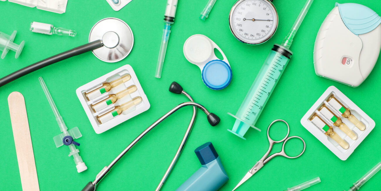 Flat lay of medical tools on colored background. Healthcare insurance concept. Table top view essential doctor's equipment