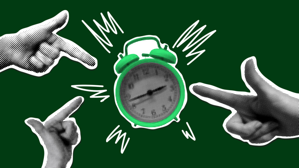 Fingers pointing at an alarm clock