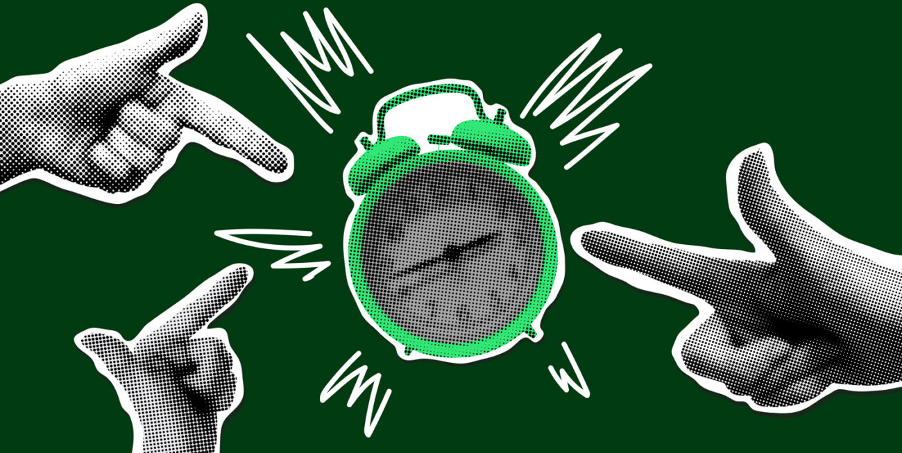 Fingers pointing at an alarm clock