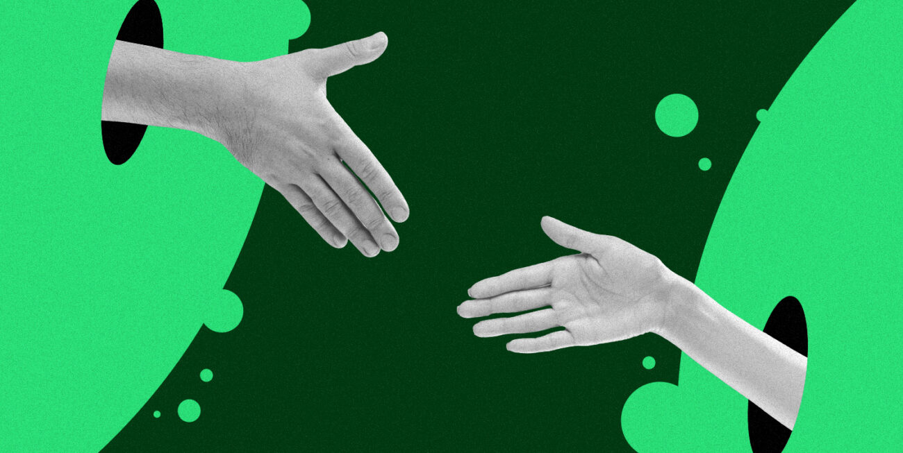 Two hands reaching out for a handshake