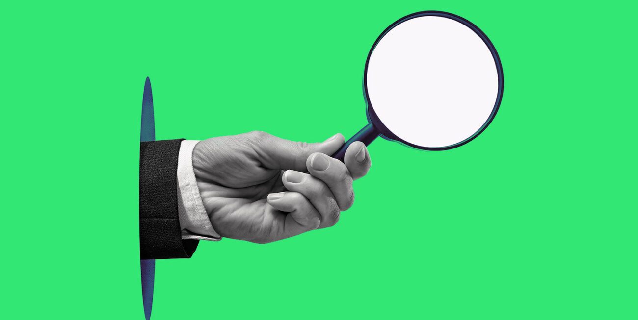 Holding a magnifying glass