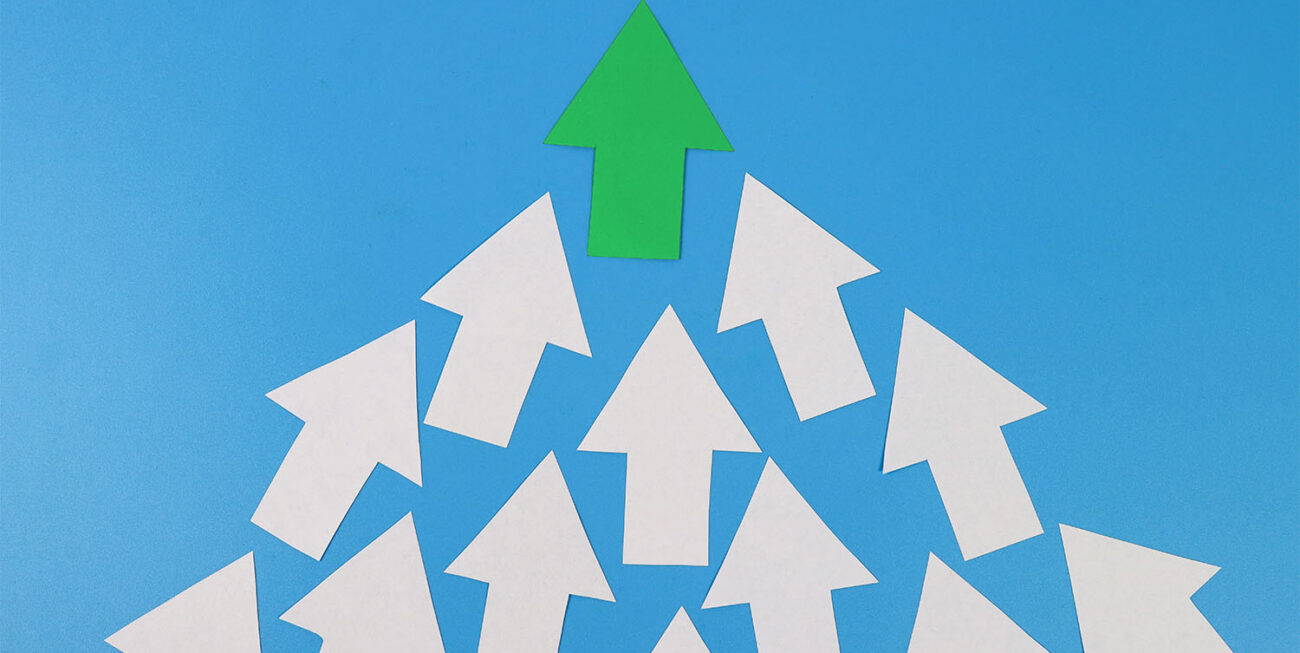 White arrows pointing up with one green arrow at the top