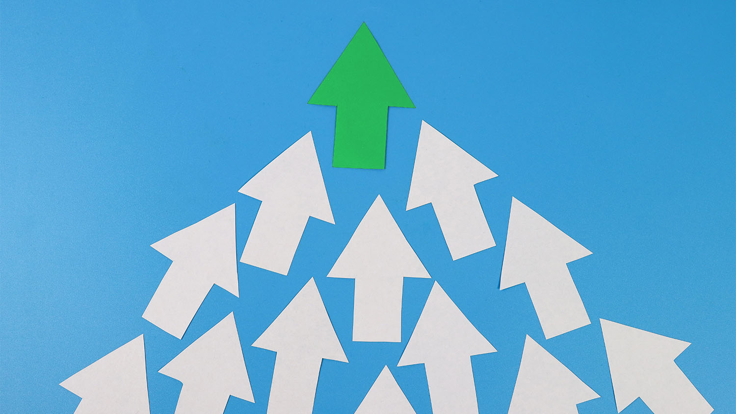 White arrows pointing up with one green arrow at the top