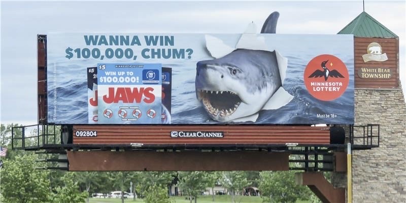 A Minnesota State Lottery billboard that showcases the film Jaws by Steven Spielberg A Minnesota State Lottery billboard that showcases the film Jaws by Steven Spielberg