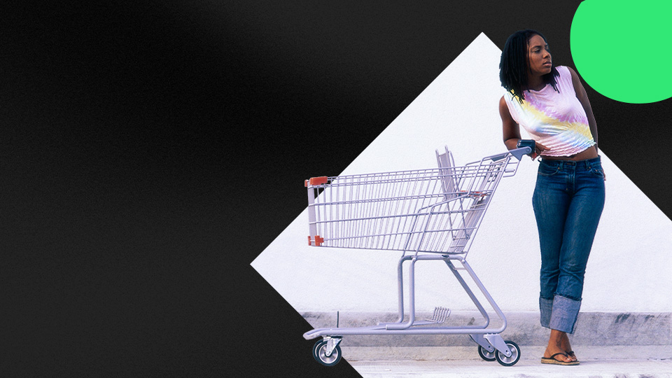 A woman pushing a shopping cart.