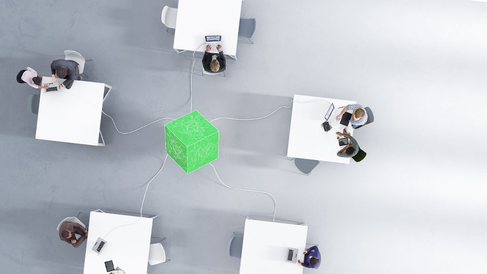Workstations connected to a green cube