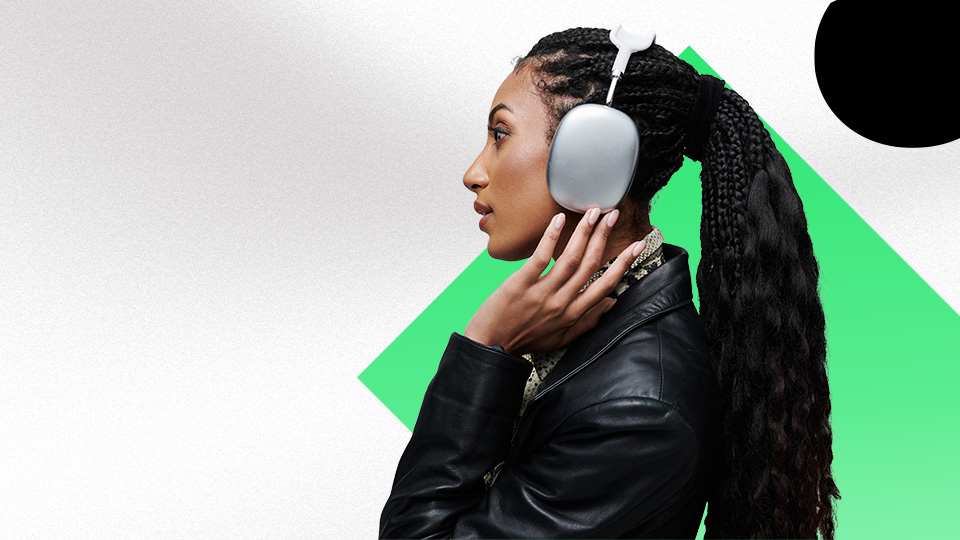 A woman adjusting their headphones.