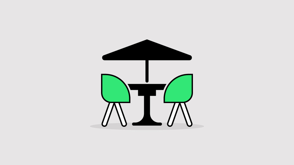 Two chairs and a table positioned under an umbrella