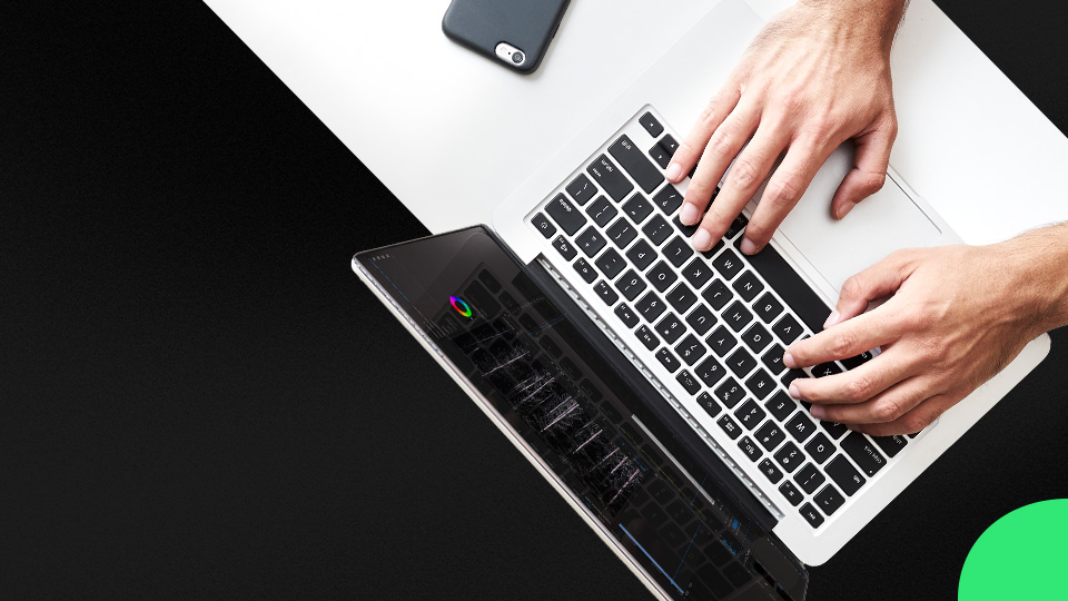 A pair of hands typing on a notebook computer.