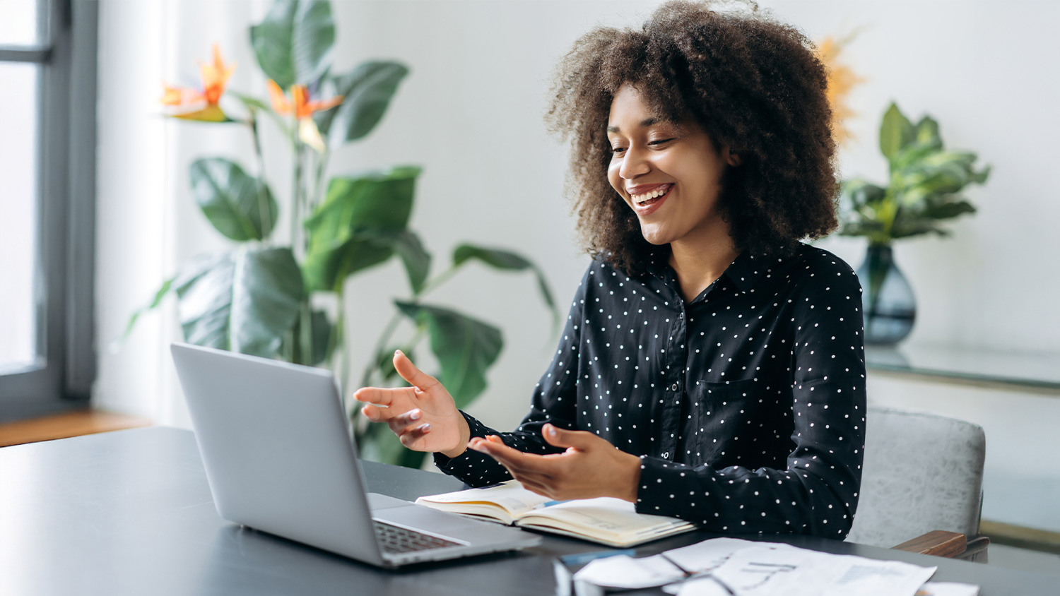 A woman engaged in a meeting on their laptop. A woman engaged in a meeting on their laptop.