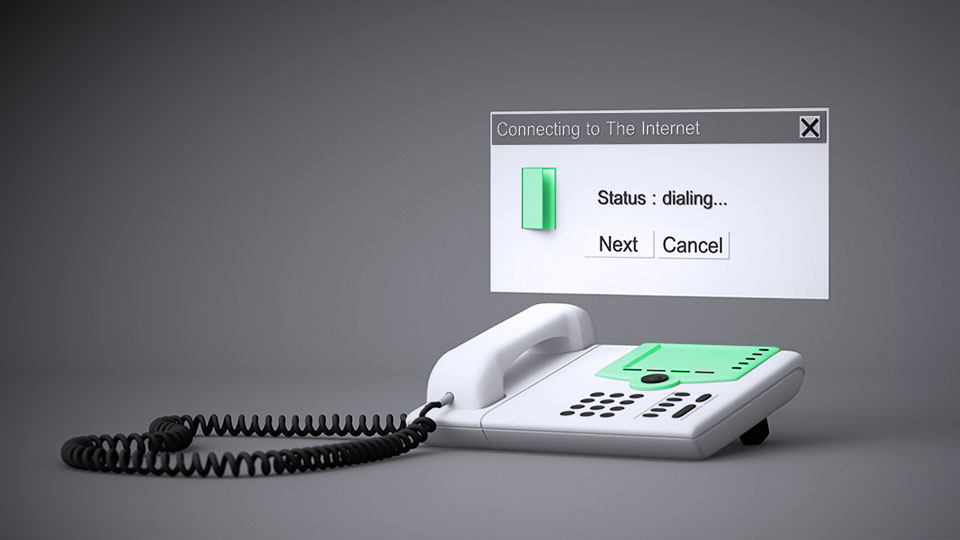 A dial-up dialog box suspended above a corded landline phone.