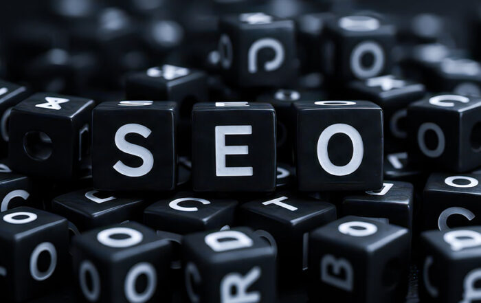 Several word cubes in a pile, with three cubes spelling "SEO" as the focus.