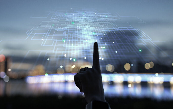 A finger touching the digital realm while outdoors.