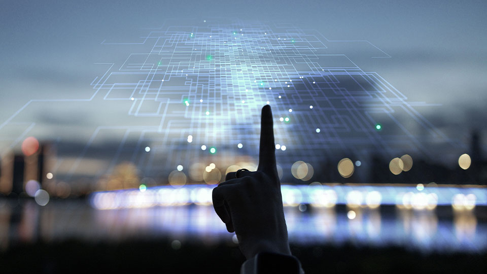 A finger touching the digital realm while outdoors.