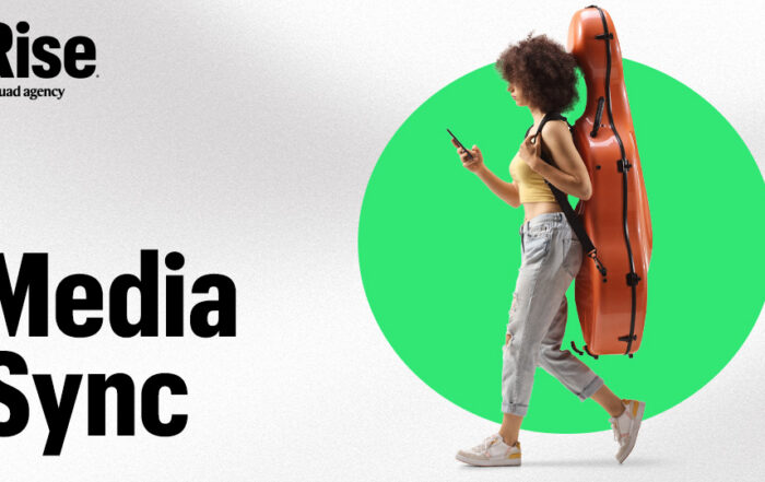 A woman walking with their phone in their hand, carrying a cello case on their back. Text reads: Media Sync