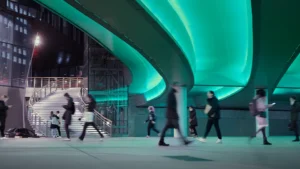 Busy travelers walking through an illuminated pathway