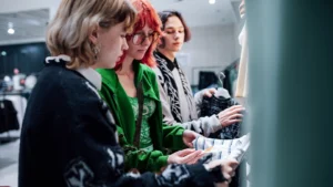 Young shoppers touching clothes in a store